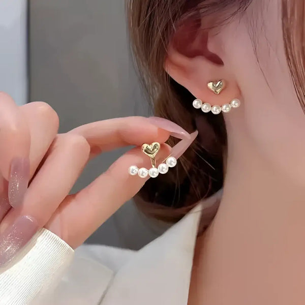Aretes mujer perlas colgantes joyería elegante Colombia